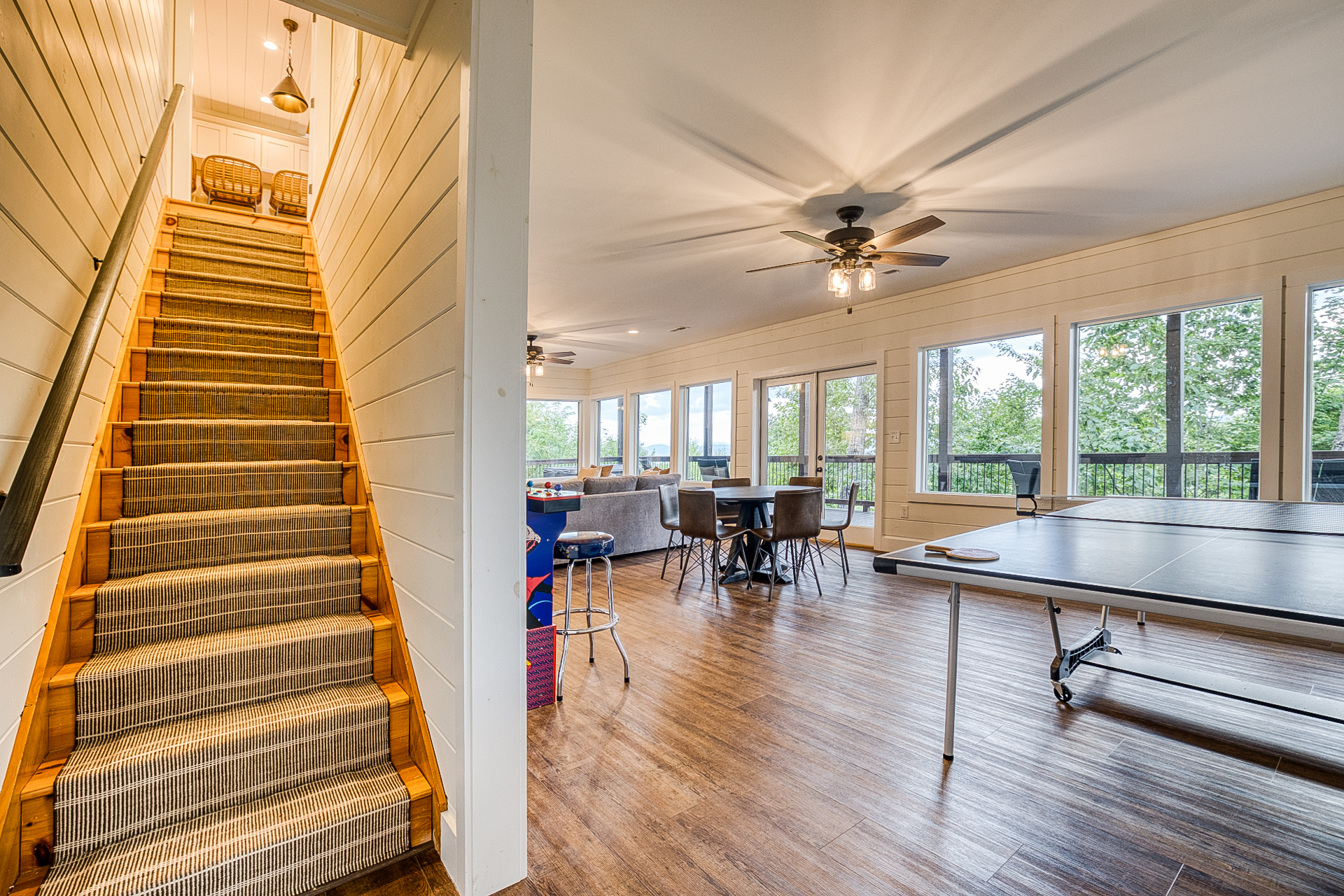 Downstairs game room with video games and ping pong table