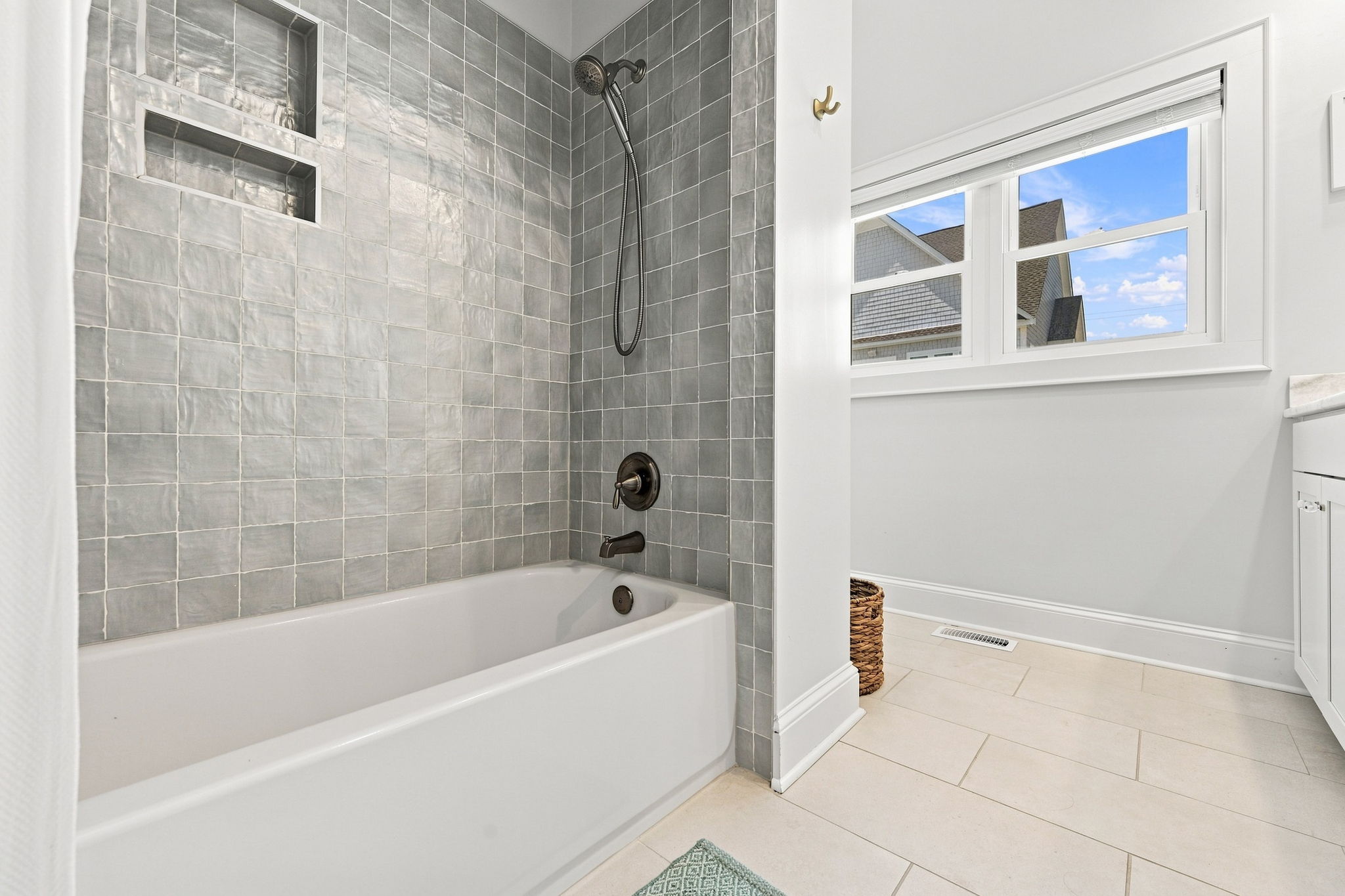 Beautifully updated full hall bathroom with modern finishes and coastal-inspired touches. Easily accessible from the queen bedroom and central living space, offering comfort and convenience for all guests.