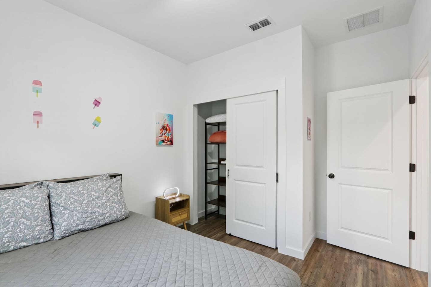 Bedroom has Queen Bed, twin trundle under bed, nightstand, suitcase holder, closet with hangers