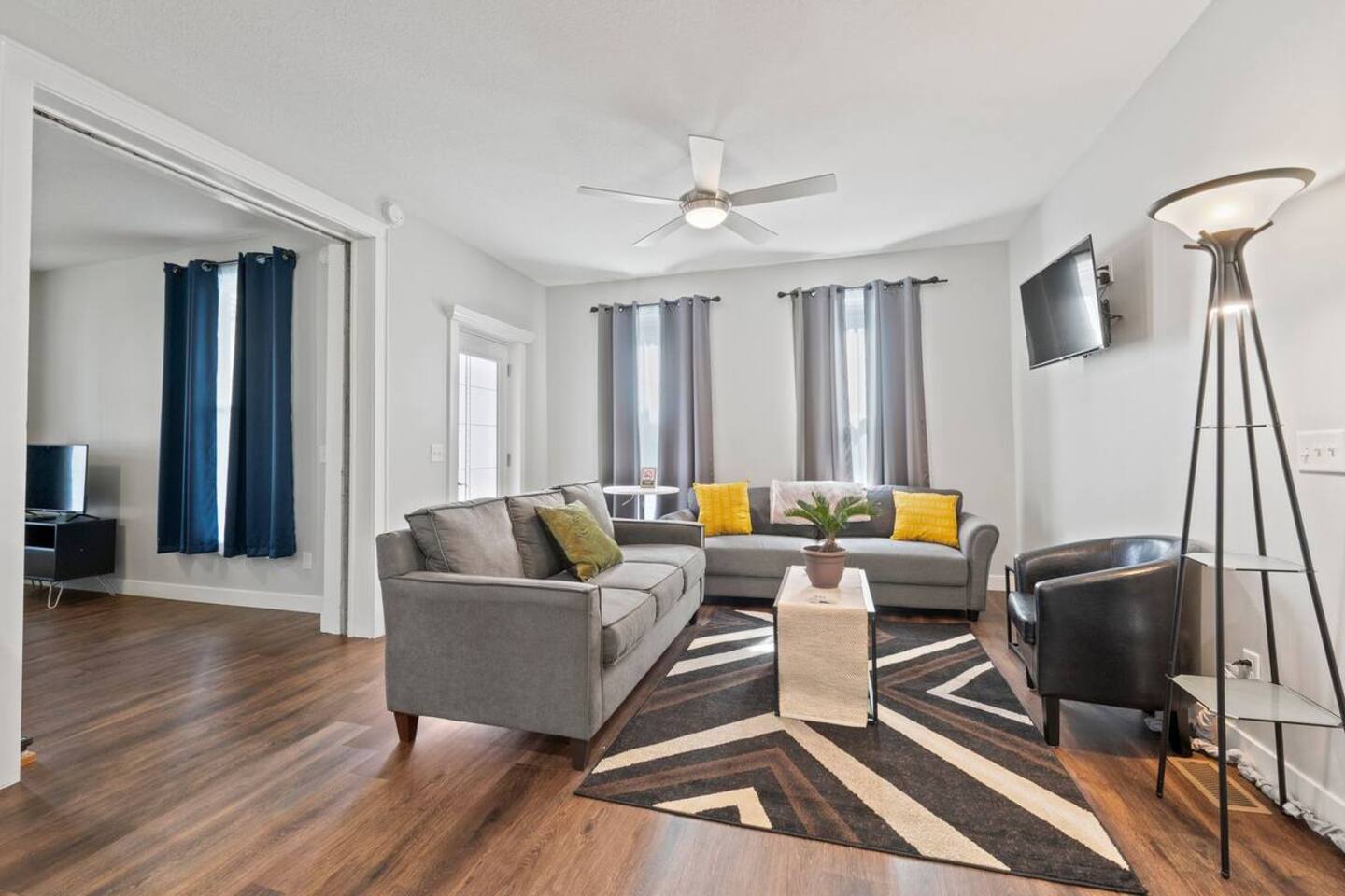 Cozy living room featuring a comfortable couch, a stylish center table, and a flat-screen TV for ultimate relaxation.