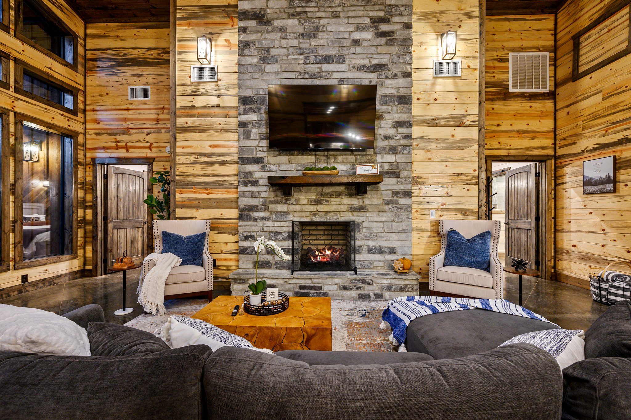 Elegant cabin living space with fireplace, soaring ceilings, and charm