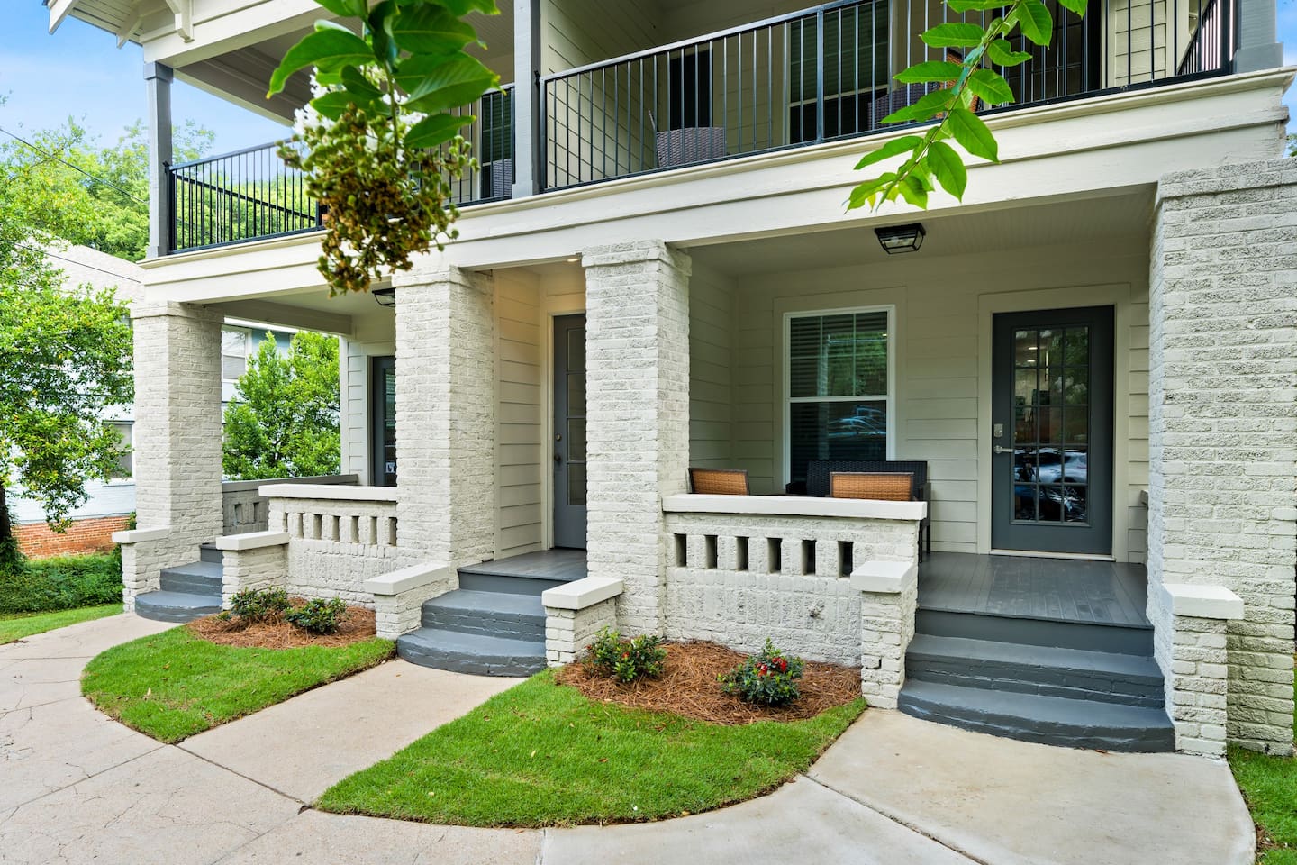 Relax on the cozy porch of Unit 2, perfect for enjoying the quiet neighborhood vibe with a morning coffee or winding down in the evening.