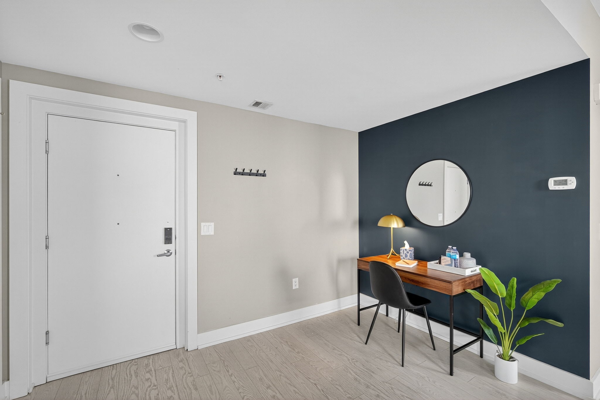 Need to get things done? A stylish desk with gold accents, comfy chair, and task lighting provides a quiet, productive nook.