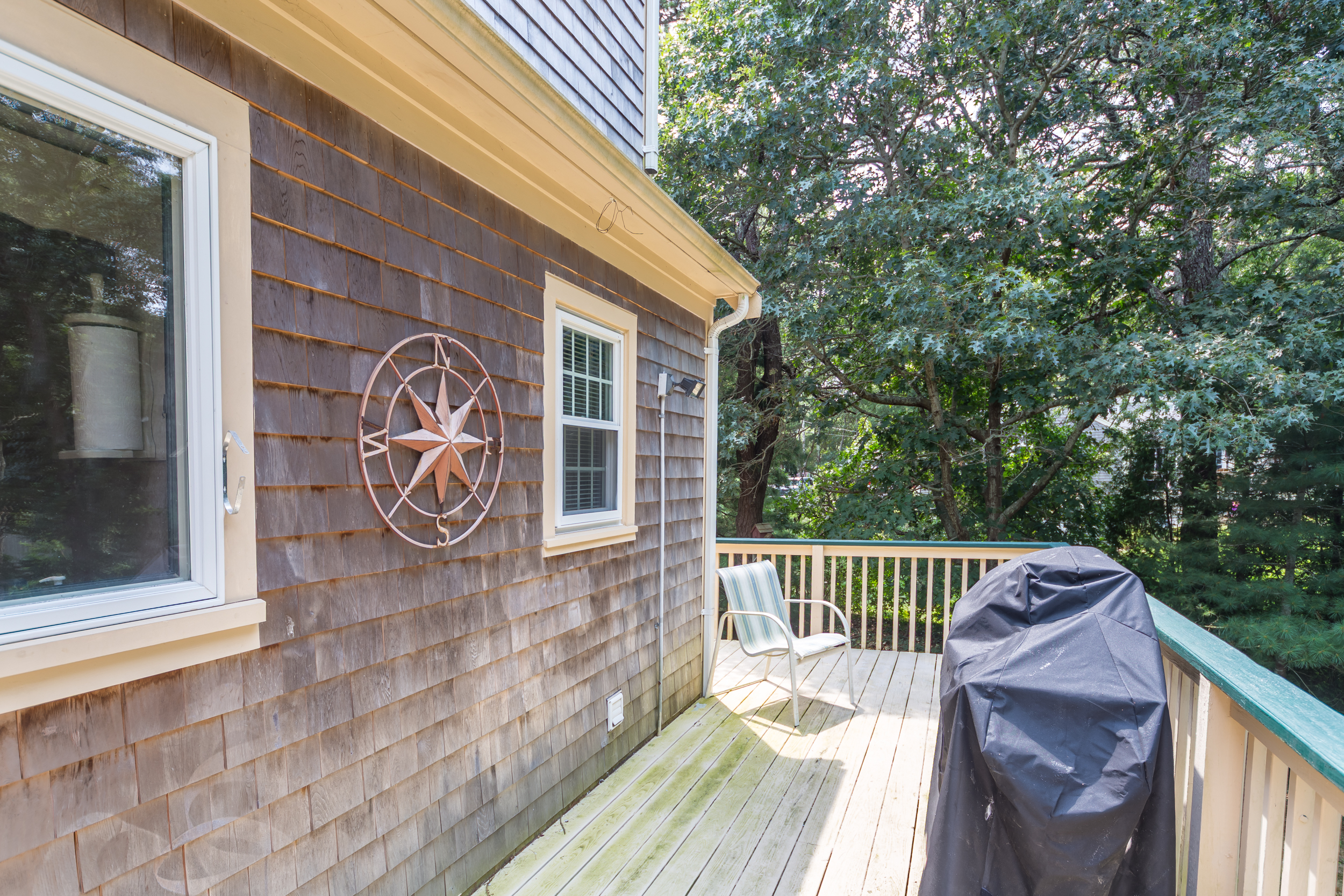 Spacious deck with grill for outdoor cooking.