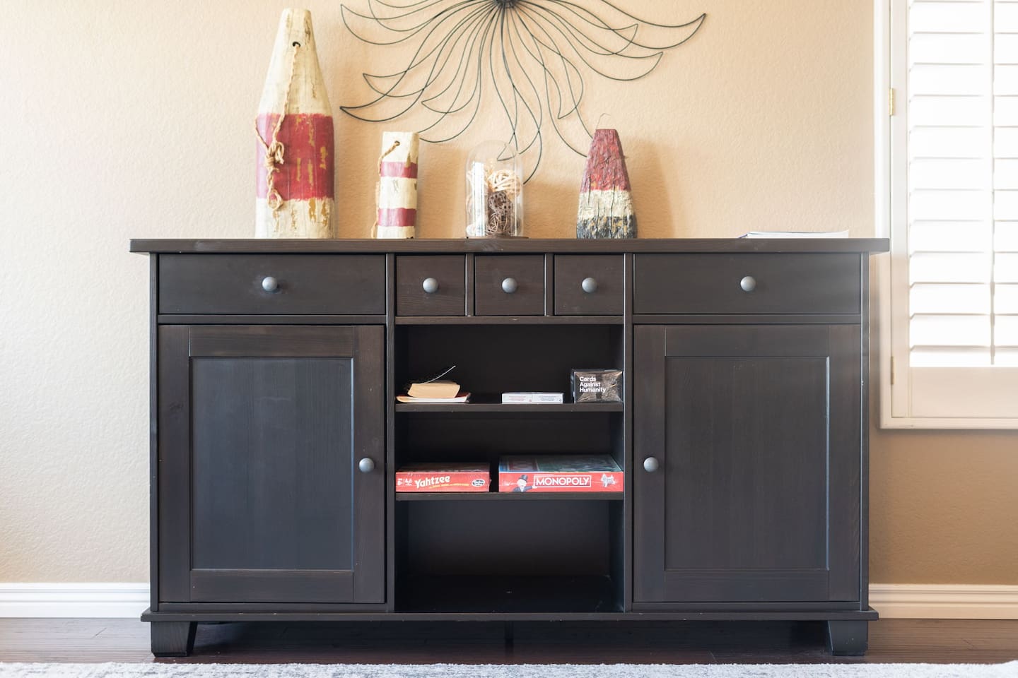 The sideboard isn't just for décor — open it up and find board games ready to go, perfect for a fun evening in with family or friends.