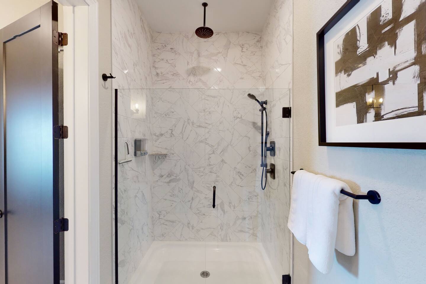 Private Master Bathroom en suite includes modern fixtures, granite counter tops, double sinks, large closet, and seperate oversized shower with rainwater ceiling shower head, floor to ceiling quartz tiles, and shower wand, plus toilet.