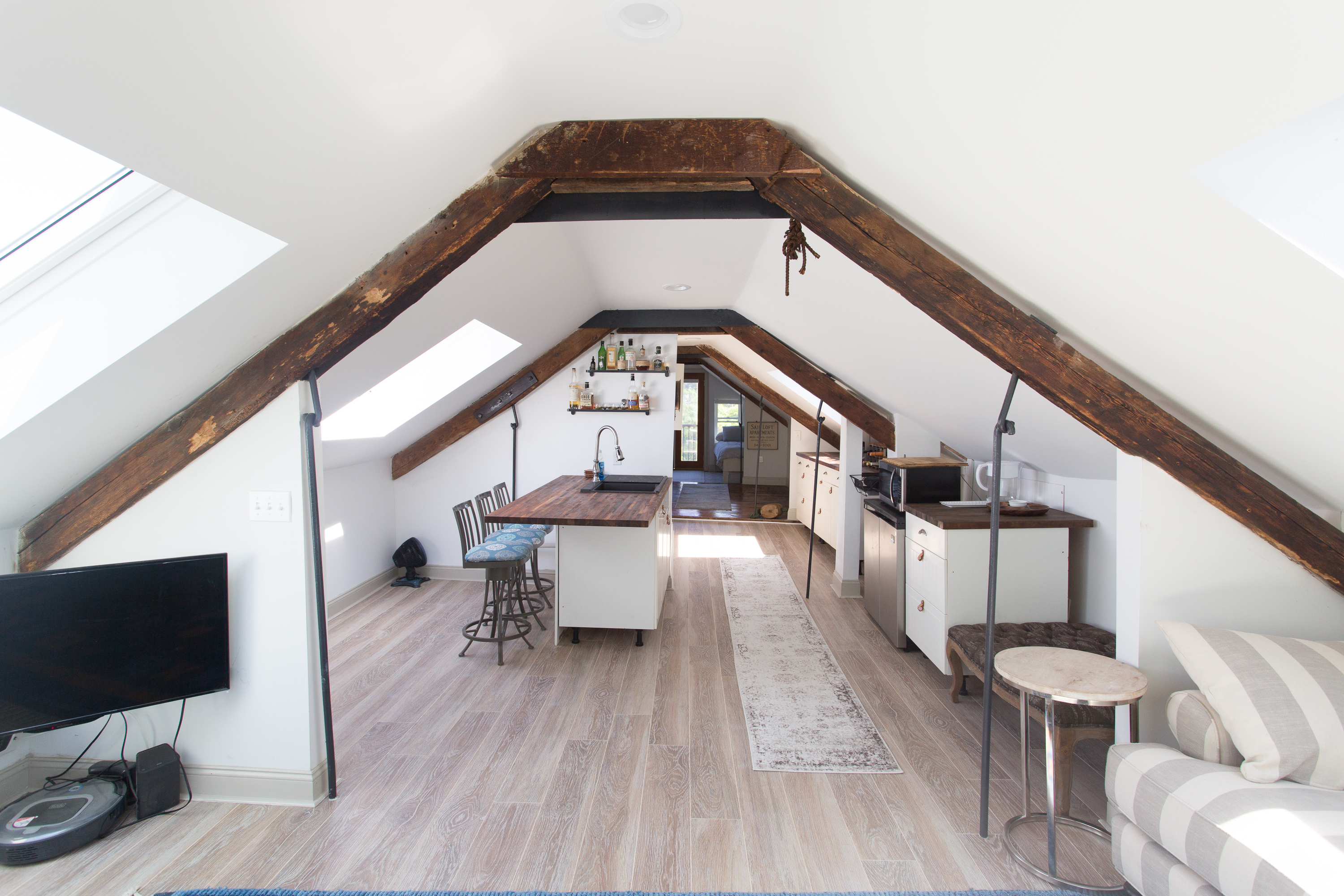 Charming Loft Kitchen: Enjoy culinary adventures in a sunlit space with rustic beams and modern flair!