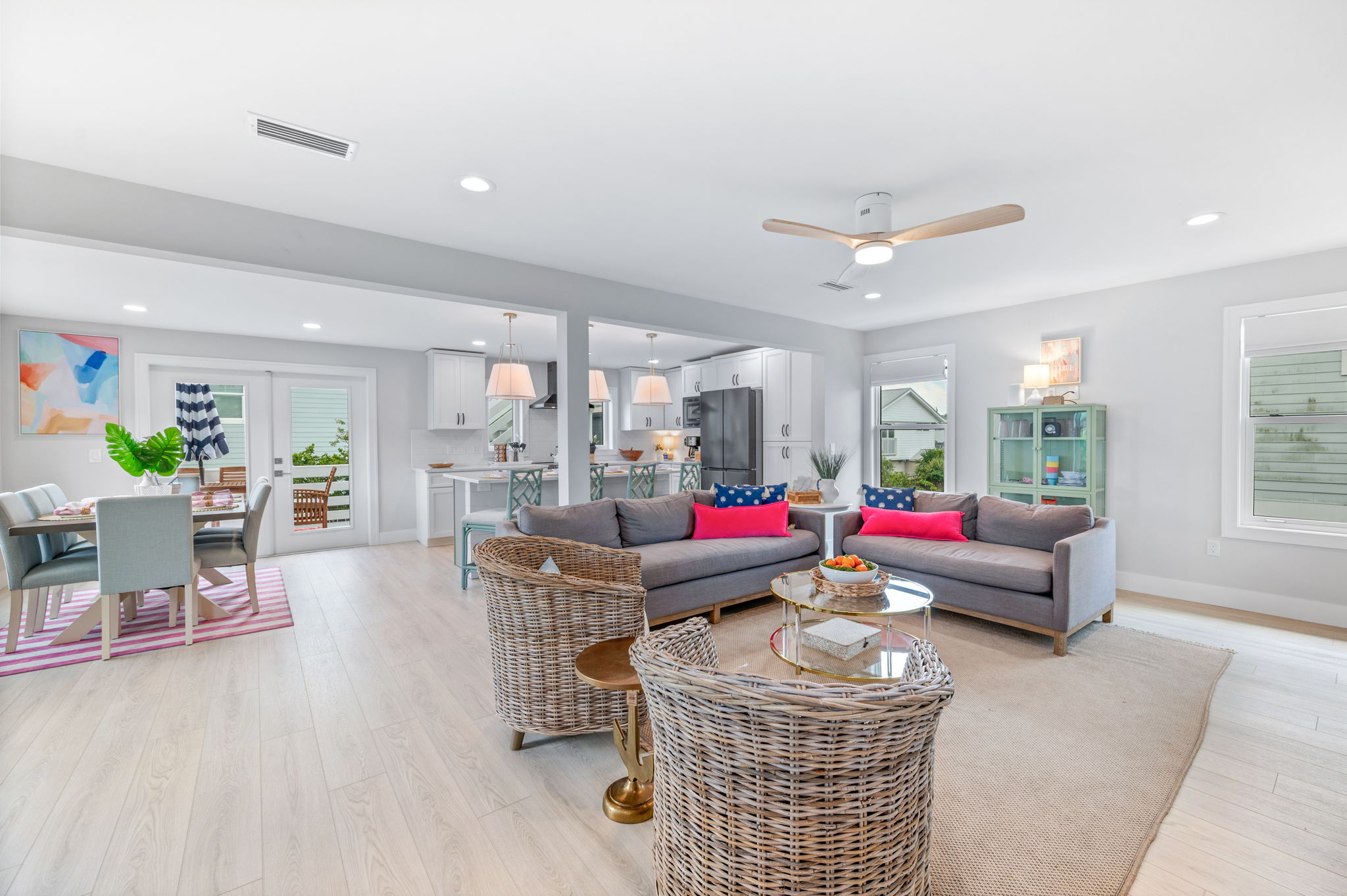 This photo captures the expansive open-concept second floor, featuring a spacious living room, dining area, and kitchen, with easy access to the outdoor deck through the door.