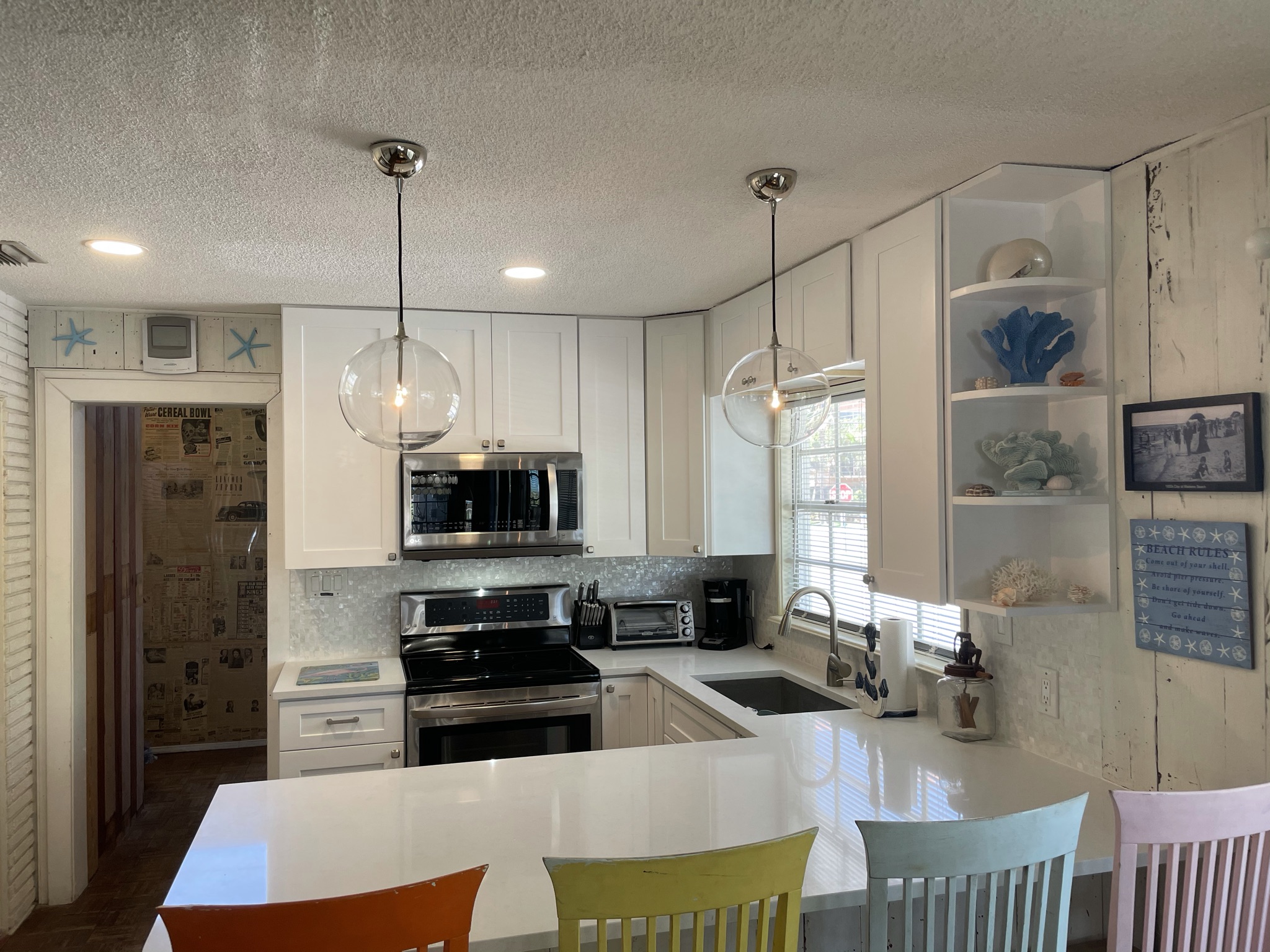 Open concept kitchen and breakfast bar,  Quartz Counter Tops, Mother of Pearl Backsplash, Restoration Hardware Pendant Lights