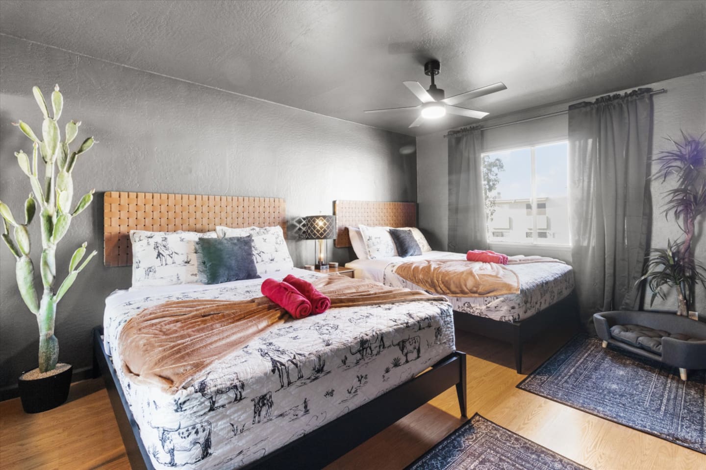 Bedroom with two queen beds, soft lighting, and plenty of space for family or friends.
