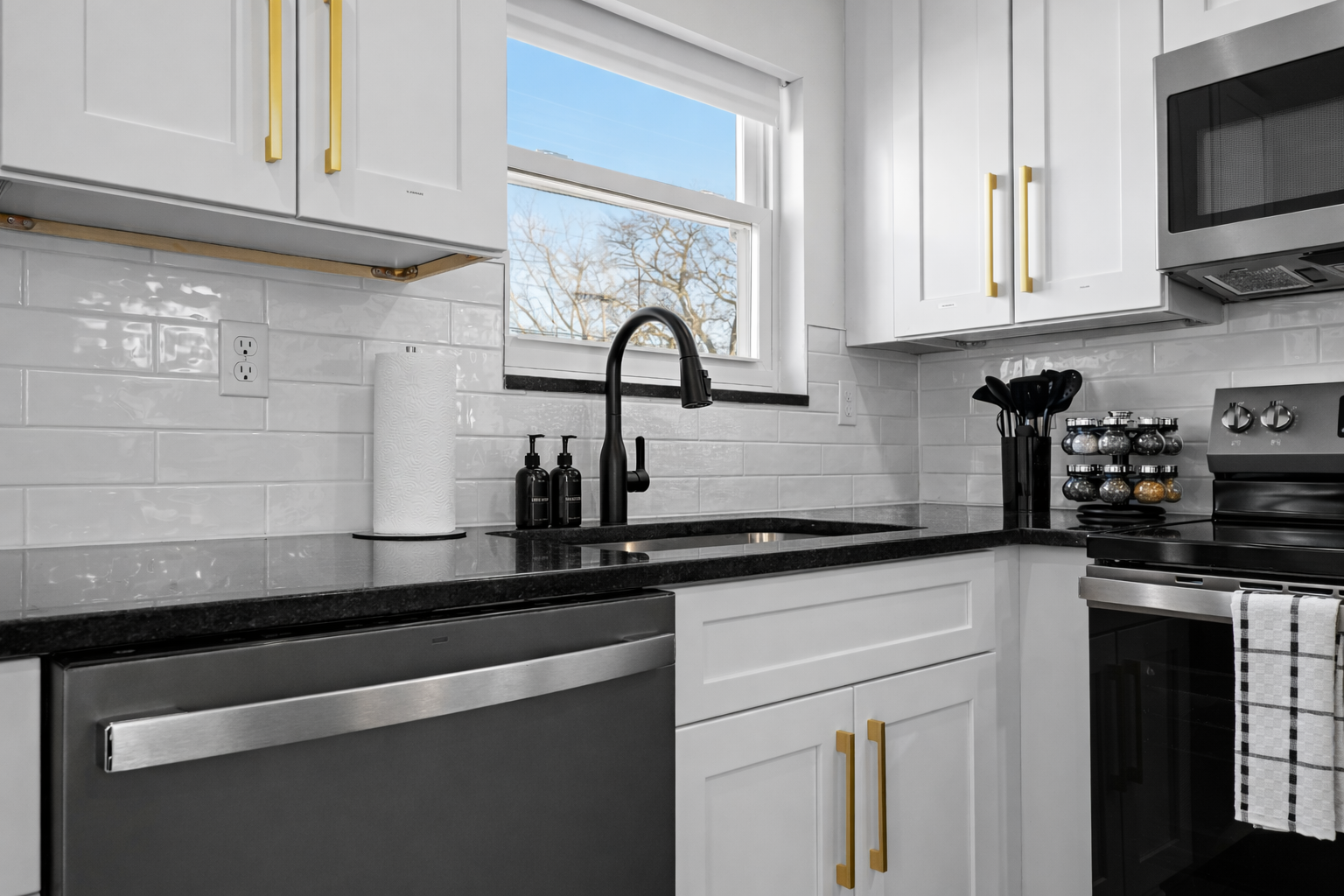 Stylish, modern kitchen with sleek countertops, quality appliances, and a bright window—making cooking and cleanup feel effortless.