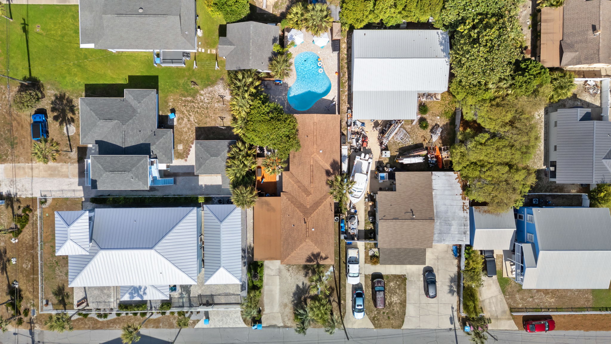 Seen from the air, your private deck and pool stand out among the neighborhood. A rare backyard oasis just 1 block from the Gulf.
