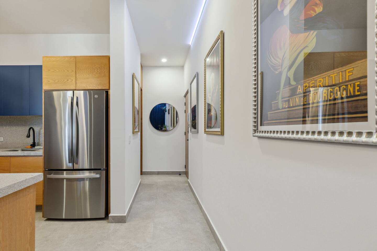Ceiling LED-lit entry hallway leading to the kitchen and living room, creating a warm, inviting ambiance.