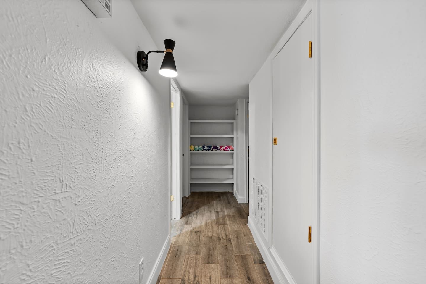 Clean, wide hallway with modern finishes that connect the home’s stylish layout.