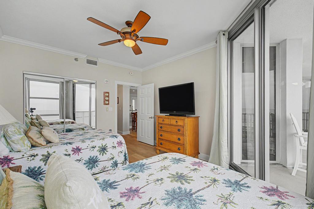 Second bedroom, 2 double beds with balcony access.