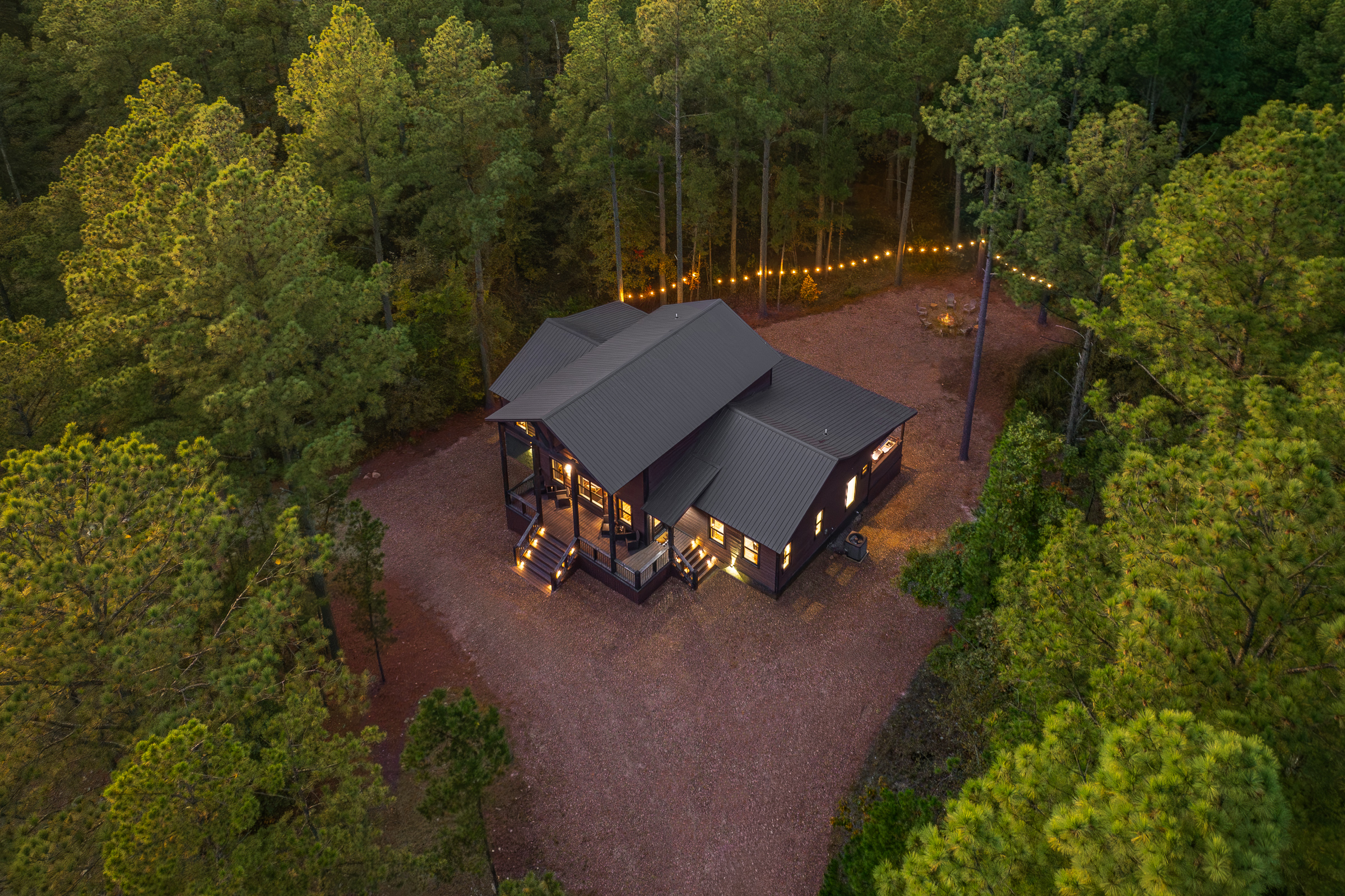 A serene aerial view showcasing the cabin’s peaceful wooded setting and total privacy. Your own forest getaway.