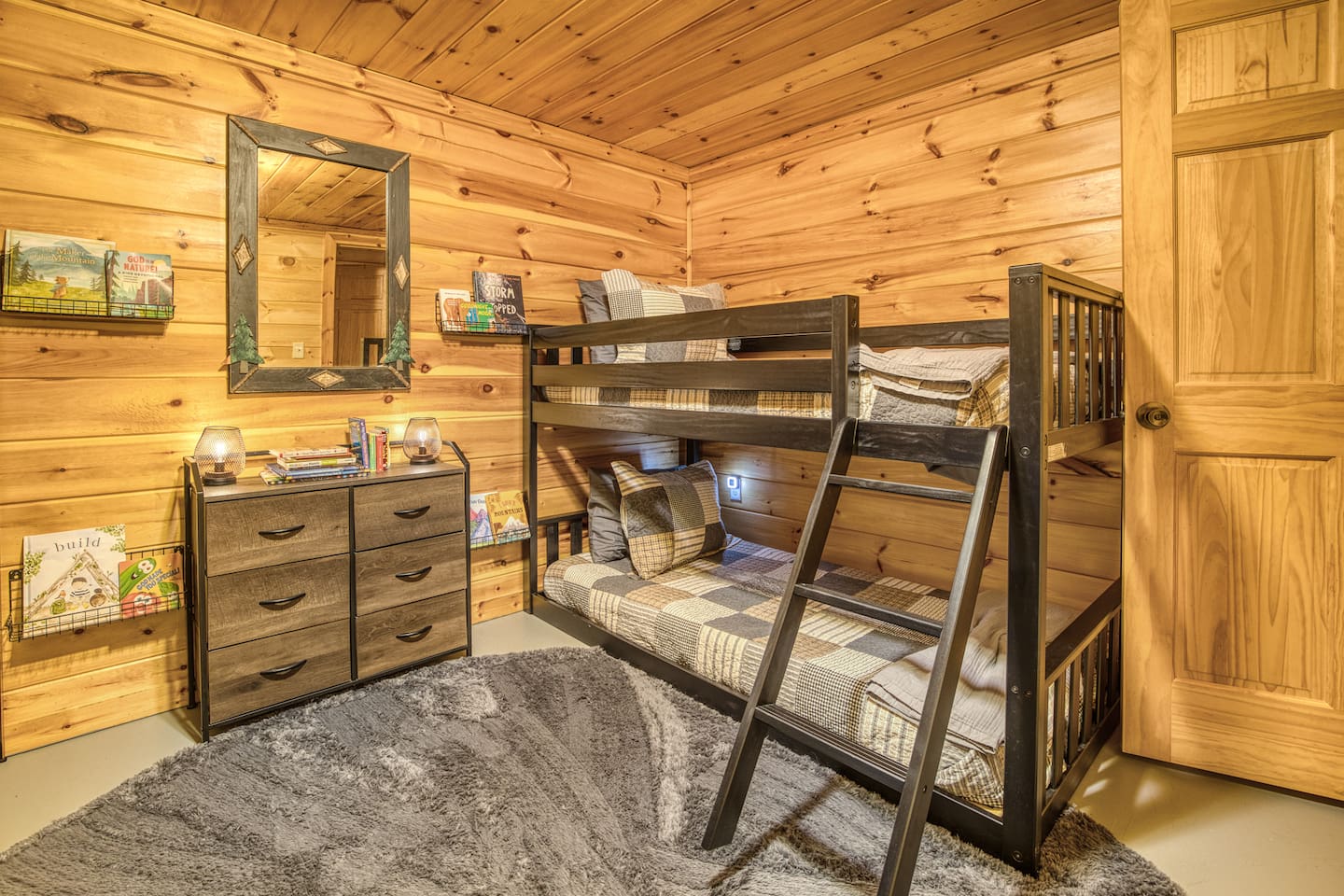 Basement bedroom with 2 bunkbeds, each with 2 twin beds (4 total twin beds) - great for kids! Includes kids' books, reading corner and wall sensory toy. 