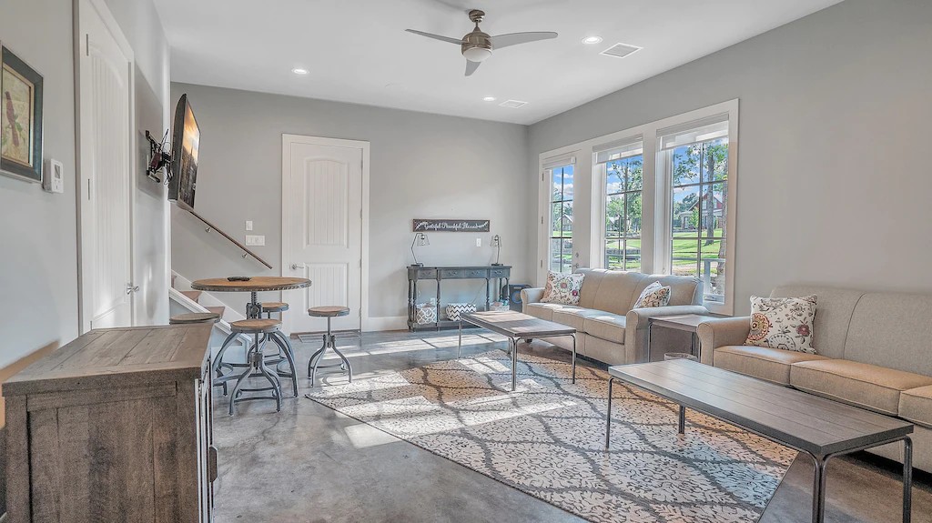 Downstairs living room with TV and more dining table seating.
