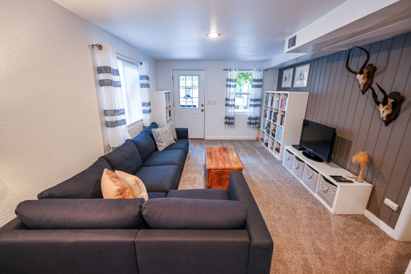 Downstairs living room with television, DVD player, books, and games