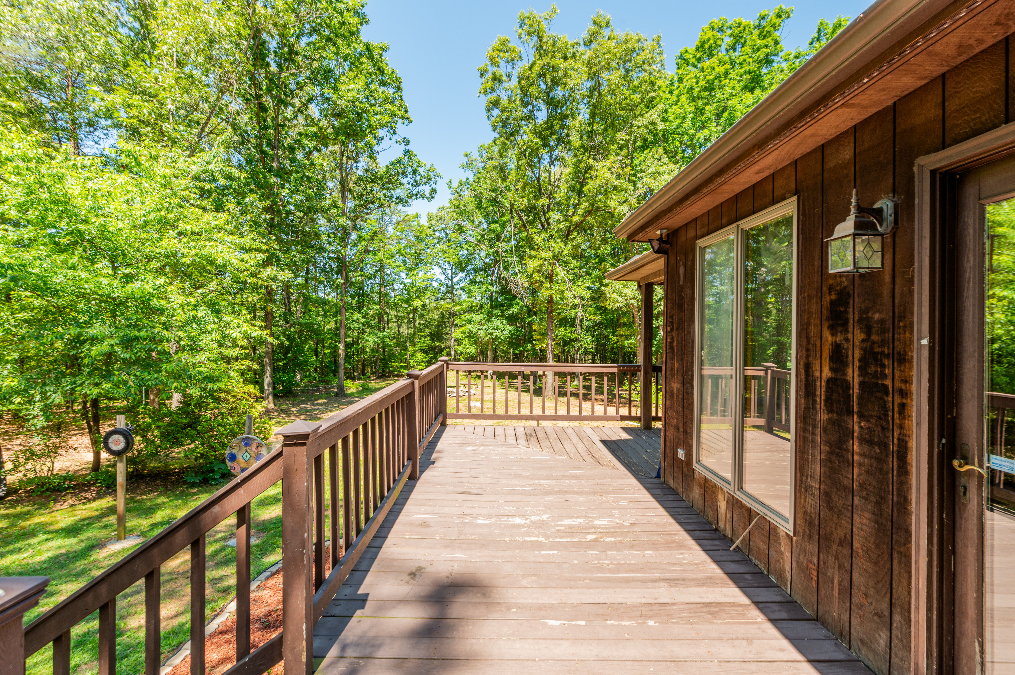 Spacious Deck Retreat: Enjoy serene woodland views and fresh air from your private outdoor escape!