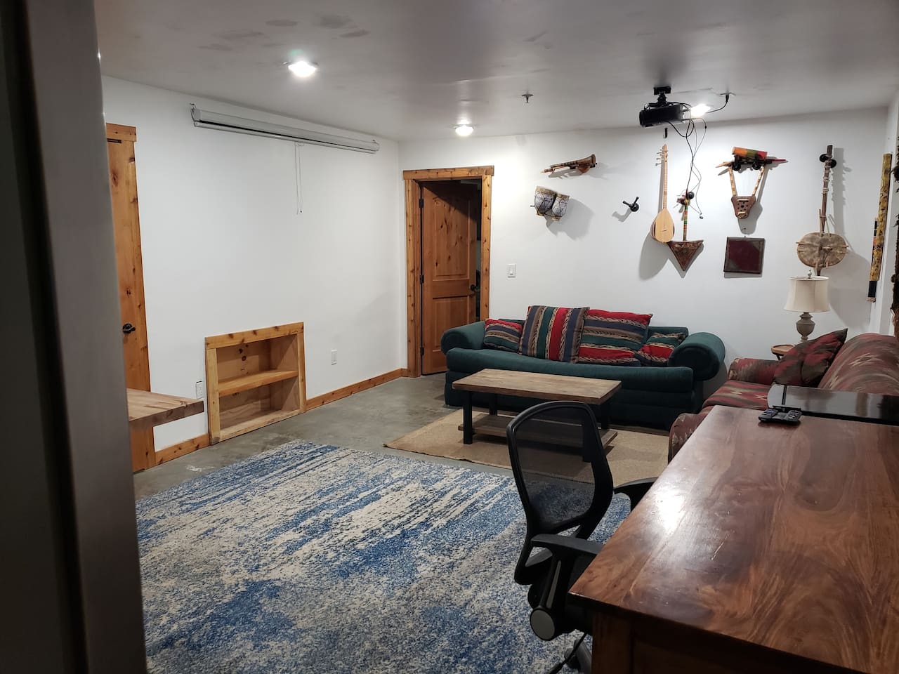 Projector movie space, Rosewood desk. Instrument collection. 