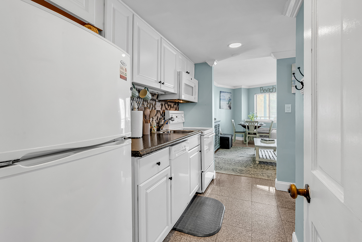 Fully equipped kitchen with full-size refrigerator, stove, microwave, dishwasher, and blender