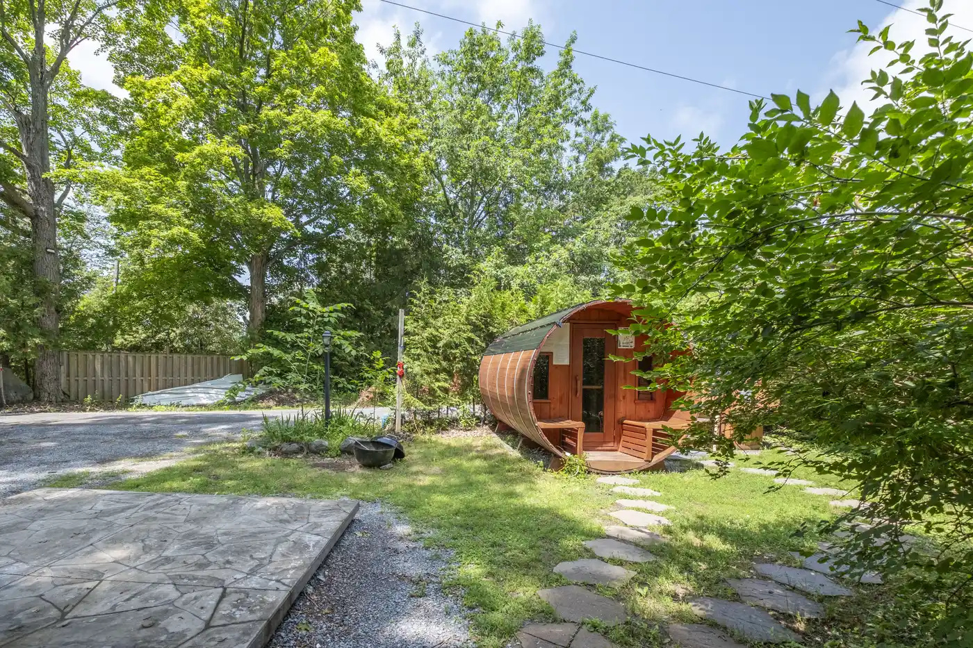 Barrel sauna and outdoor area beside Cottage #6