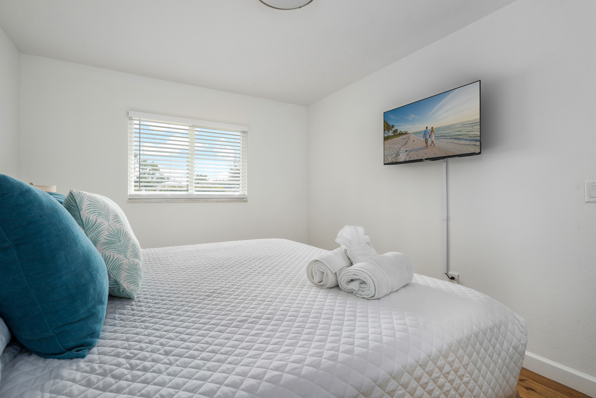 Comfortable and inviting, this king bedroom features a smart TV, bedside storage, and a closet with built-in shelving and drawers—perfect for a relaxing stay.