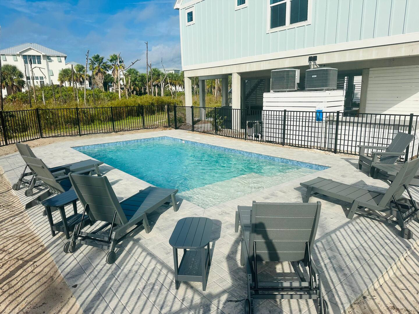 Lounge poolside or cool off in this private 16x20 oasis, featuring a 5-foot deep end and a shallow sun shelf perfect for an umbrella and relaxing in style.
