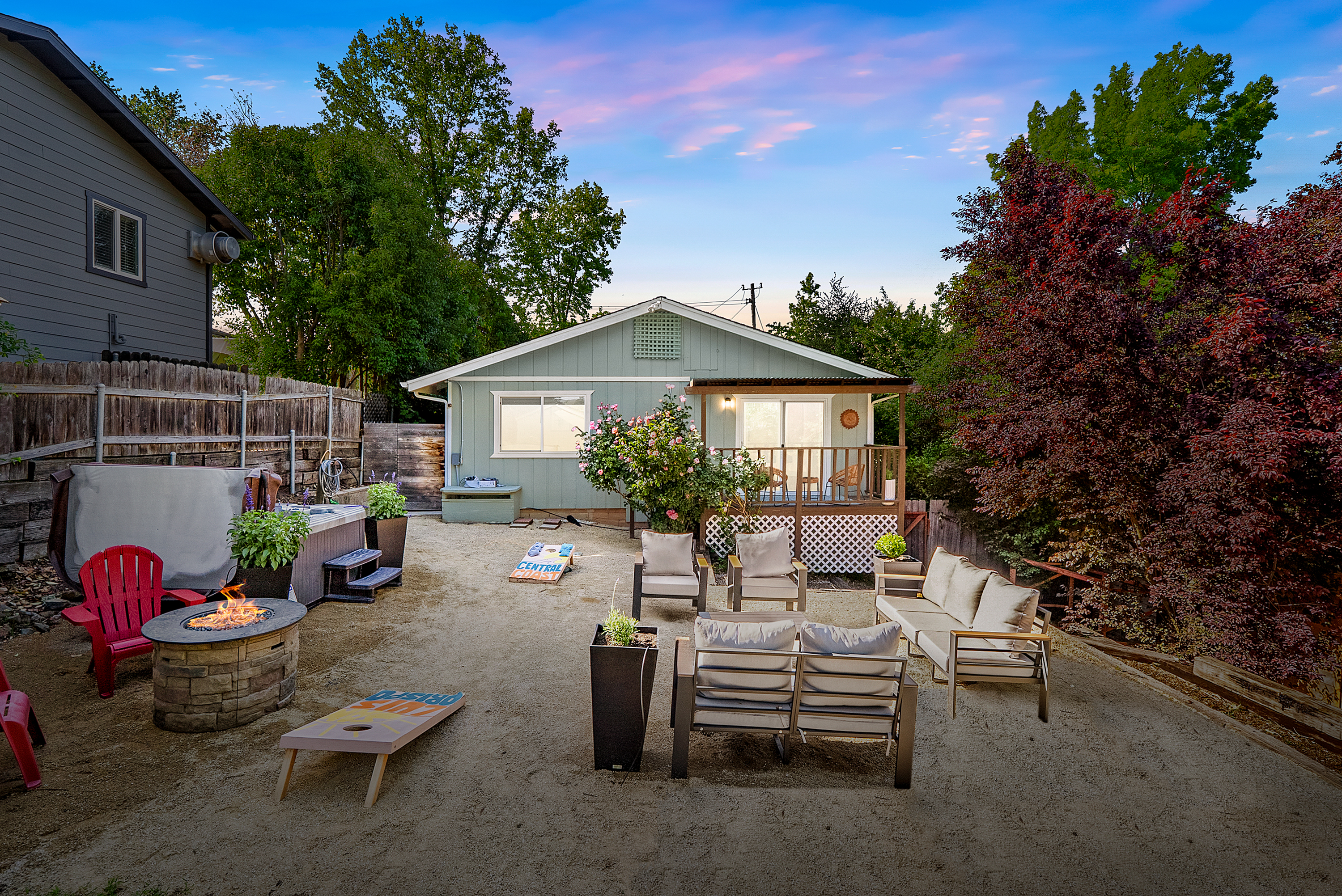 Experience the ultimate backyard escape with cozy seating and evening fun.