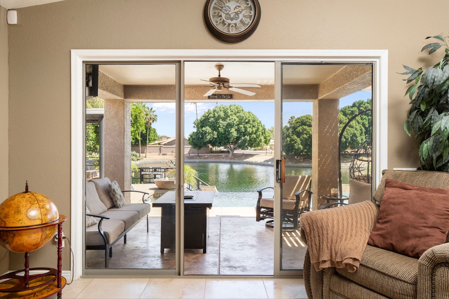 Step through the sliding glass doors to your private waterfront patio — serene lake views and outdoor seating just steps from the living room.
