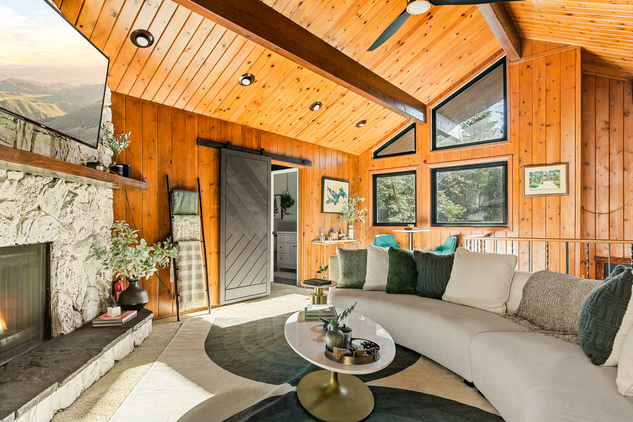 The top floor boasts an open, spacious layout, with vaulted ceilings and abundant natural light, perfect for your group to gather by a cozy fire after your adventures in Lake Arrowhead.