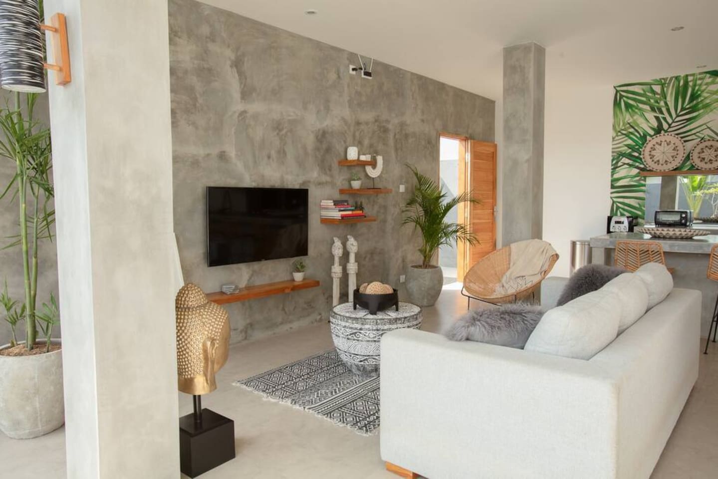 A spacious living room with a TV and some good books to read.