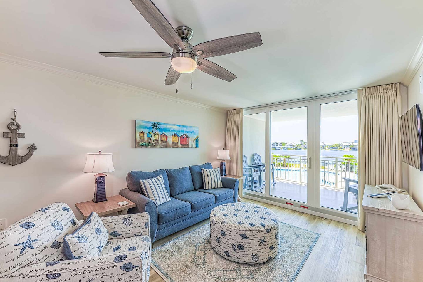 Living Room: Bright coastal vibes with stunning views and beachy decor—your perfect getaway awaits!