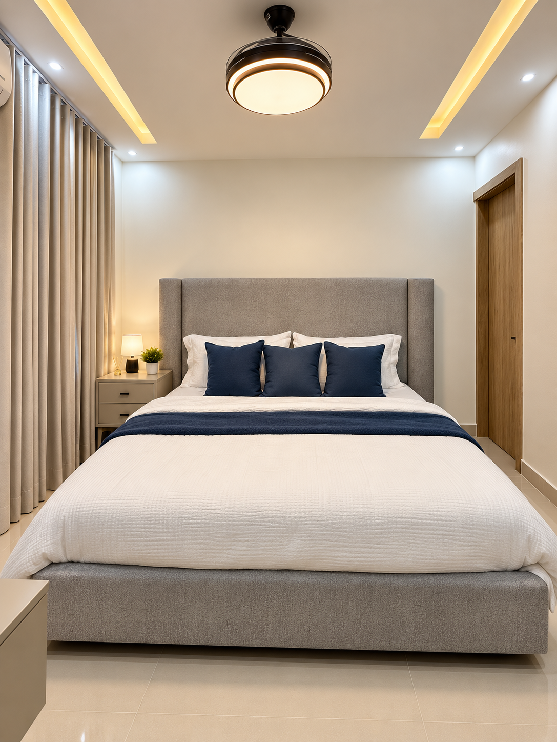 Spacious primary bedroom with a king bed, A/C, ceiling fan, TV, and vanity/workspace. 🛏️✨