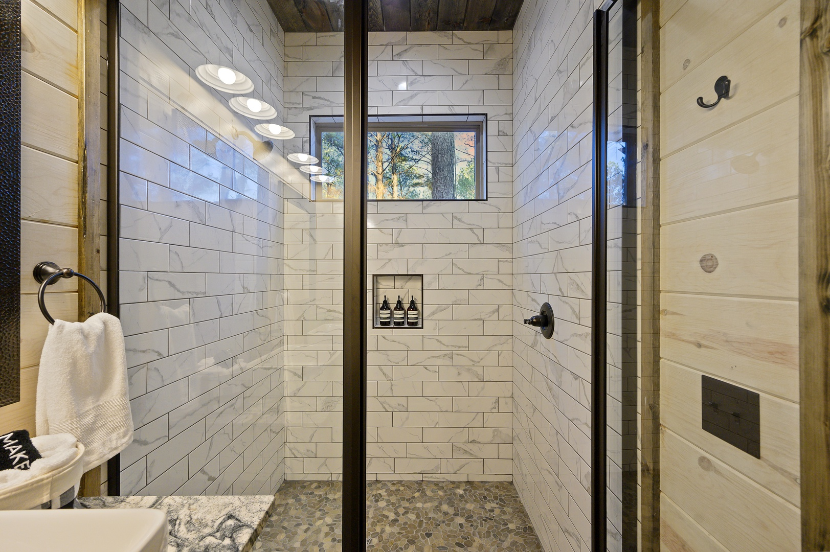 The walk-in shower feels spa fresh with crisp tile and built-in niches. Step under warm water and shake off the day.