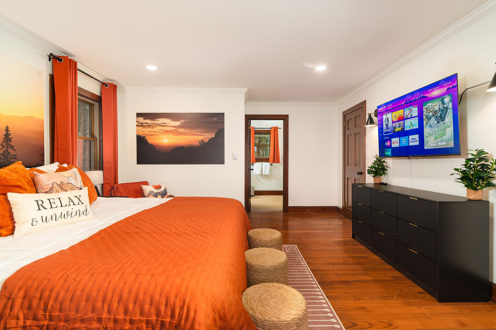 🛏 The Sunset Room primary suite — king bed, large HDTV, and a private ensuite bath.