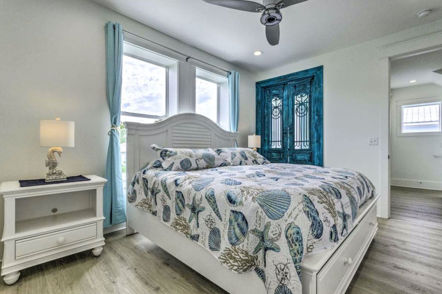 Luxury King Master: 200-year-old Antique French Doors meet modern tech. Enjoy an XL Smart TV, Supersonic fan, and a color-changing LED water shower & faucet. A bright, unique suite blending historic European charm with high-tech comfort.