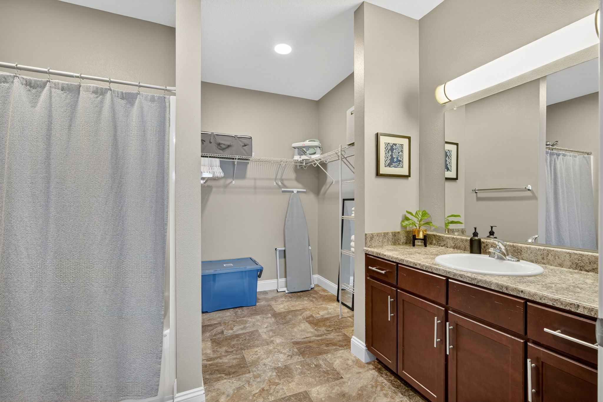 The primary bathroom features an expansive closet, vanity with tons of storage, tub/shower as well as provided linens, bathroom products and more.