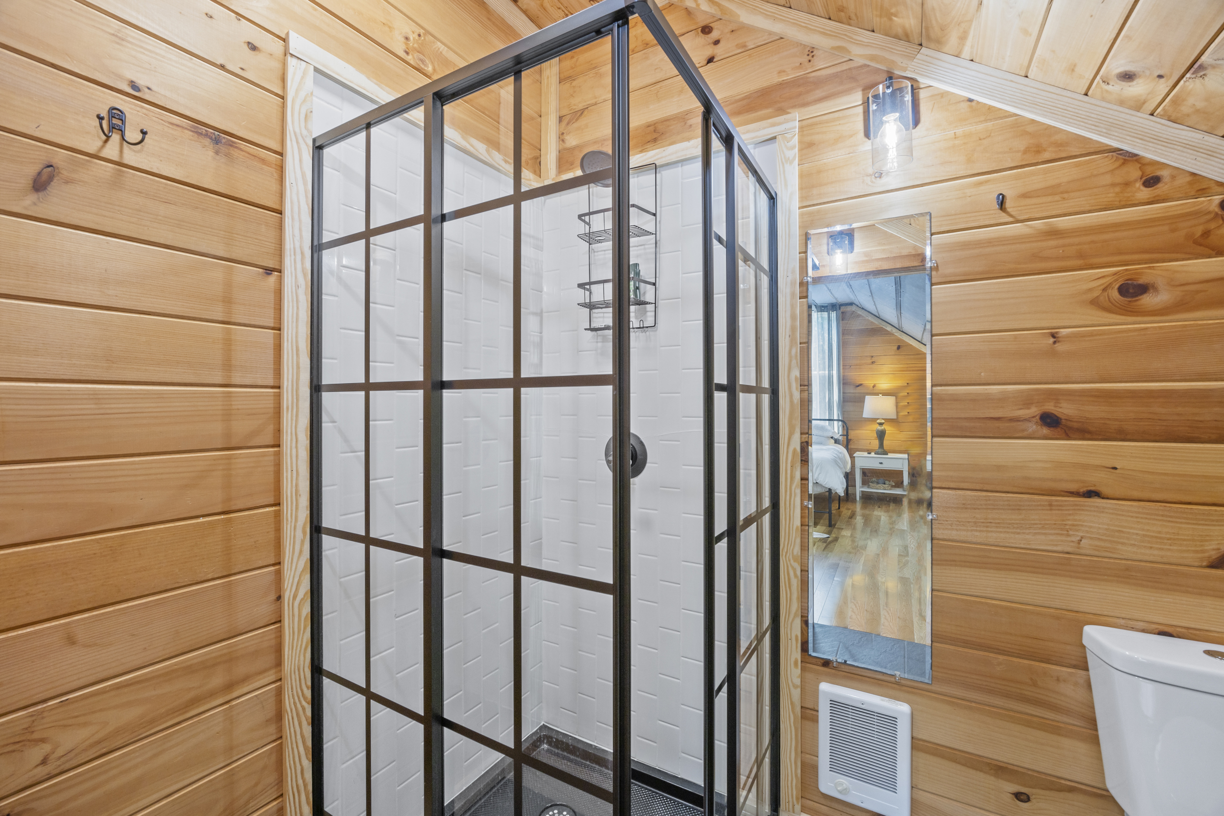Second bathroom featuring a sleek walk-in shower with black frame accents.