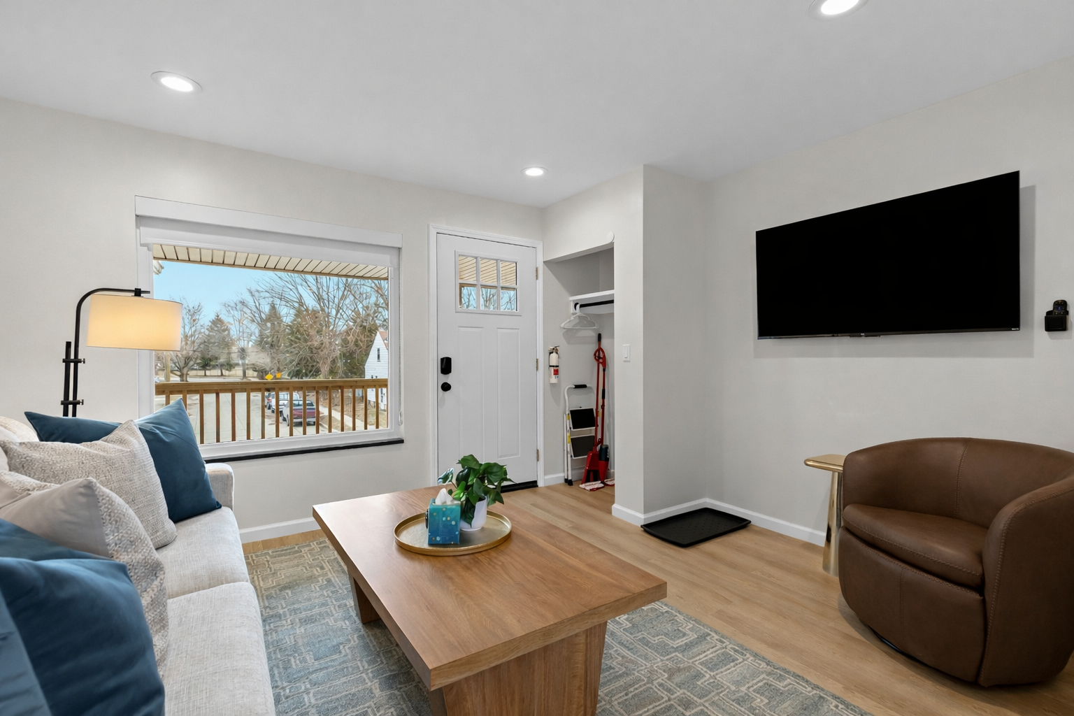 Bright, inviting living room with cozy seating, smart TV, and natural light—perfect for relaxing after a day out or enjoying a quiet night in.