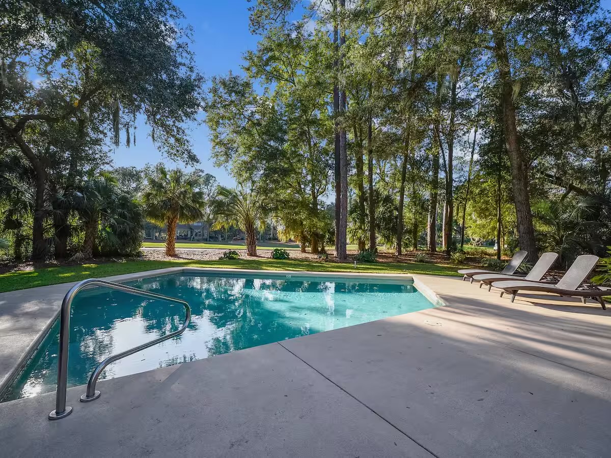View from deck overlooking pool and 11th green of Heron Pointe