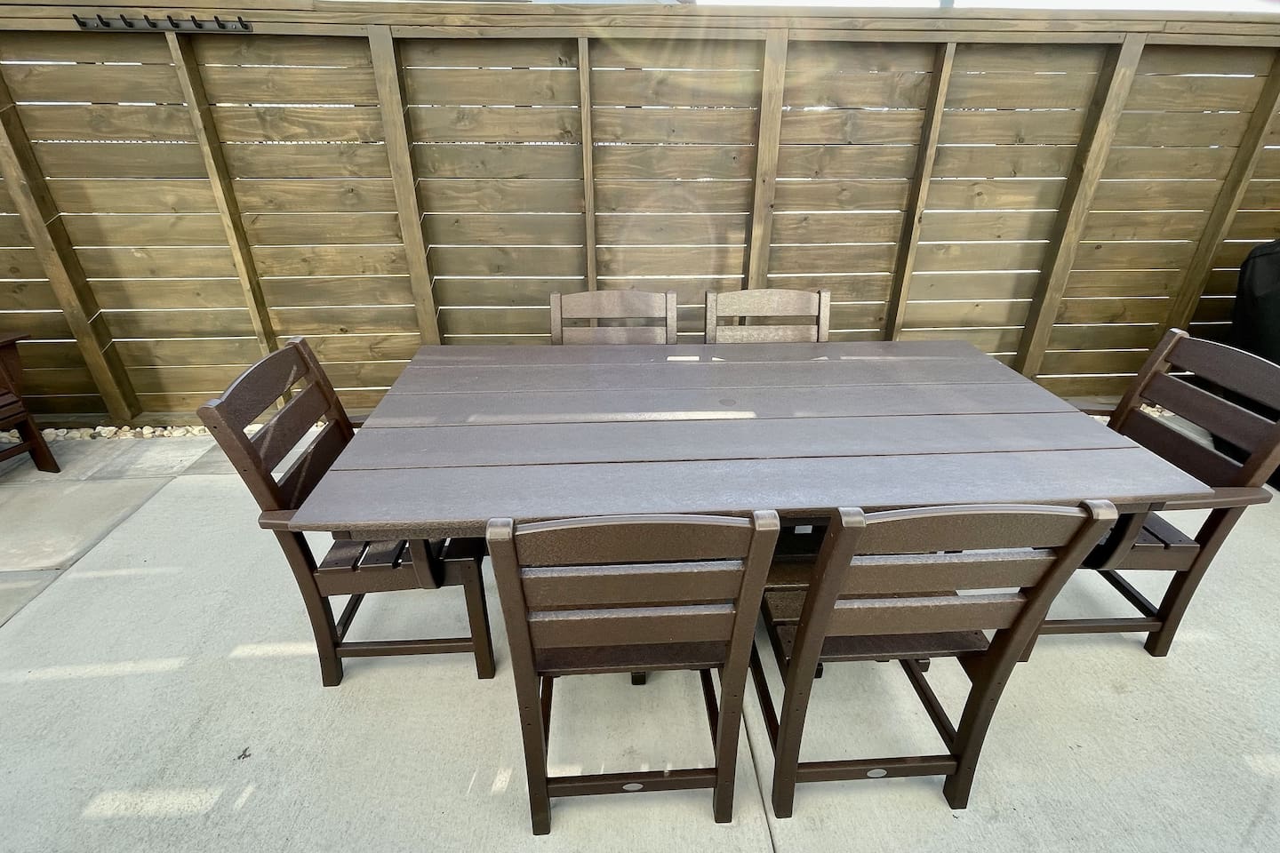 A fenced-in outdoor dining area with plenty of seating. It’s a nice, private spot to enjoy a meal outside.