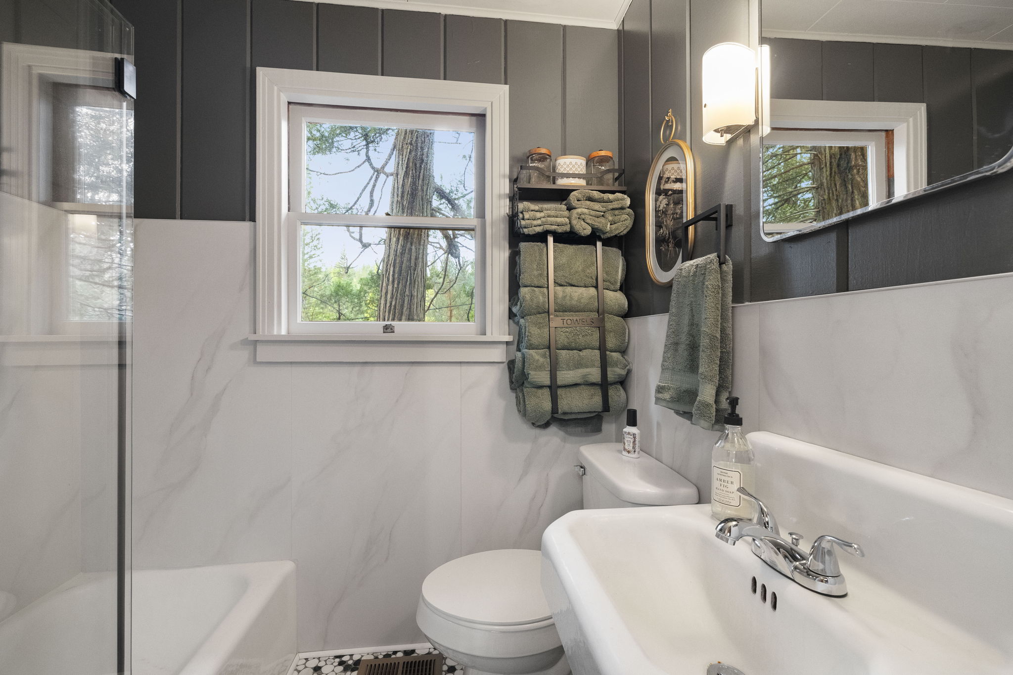 Updated charming hall bathroom with a shower/tub combo.