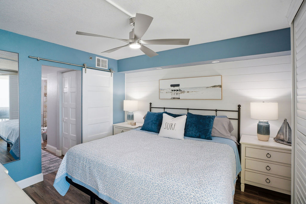 Coastal-inspired bedroom in this beachfront vacation rental featuring a king bed, modern décor, and a relaxing retreat after a day at the beach.