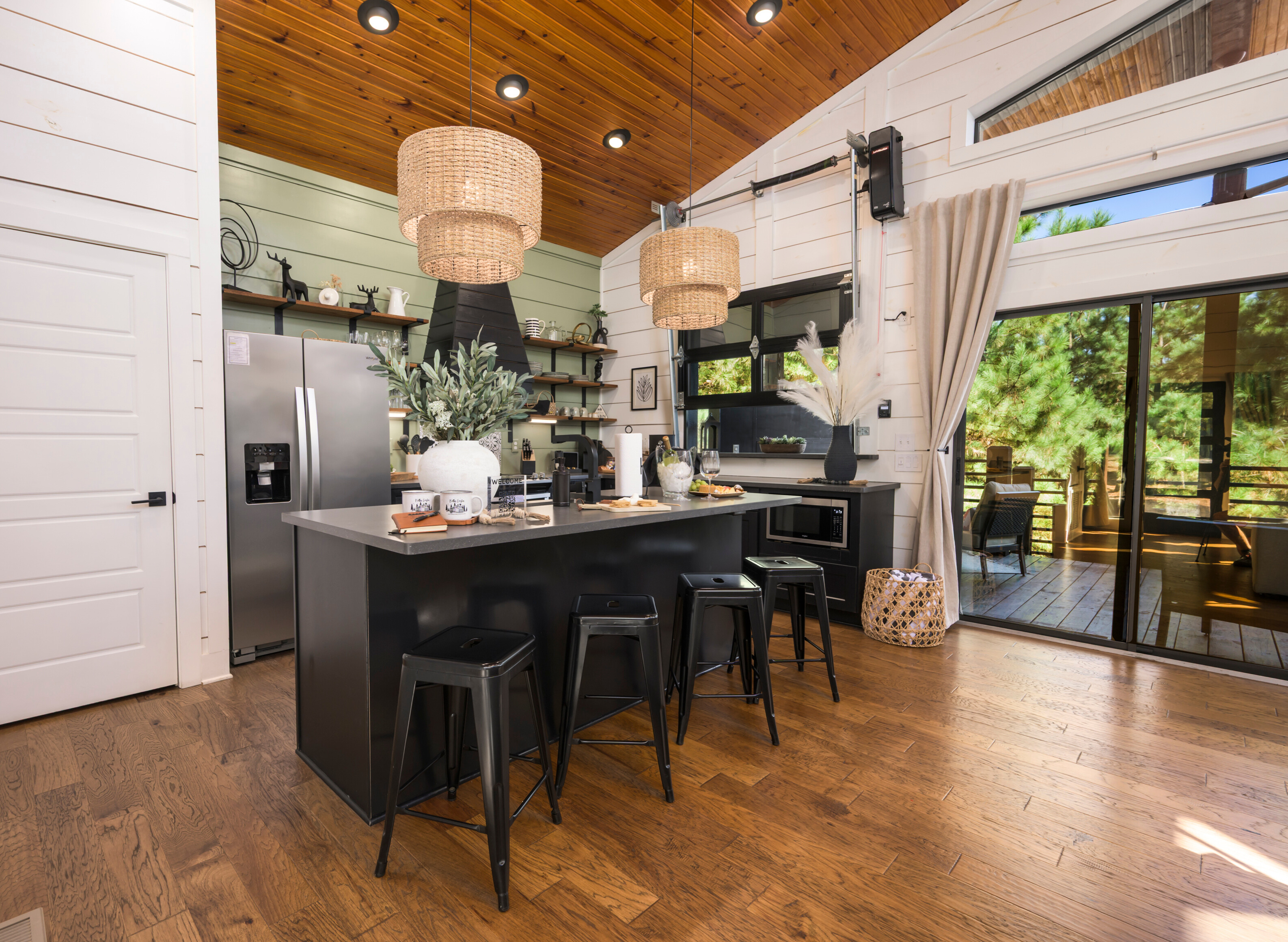 A kitchen that feels like home — cook together under warm wood ceilings and glowing pendant lights.