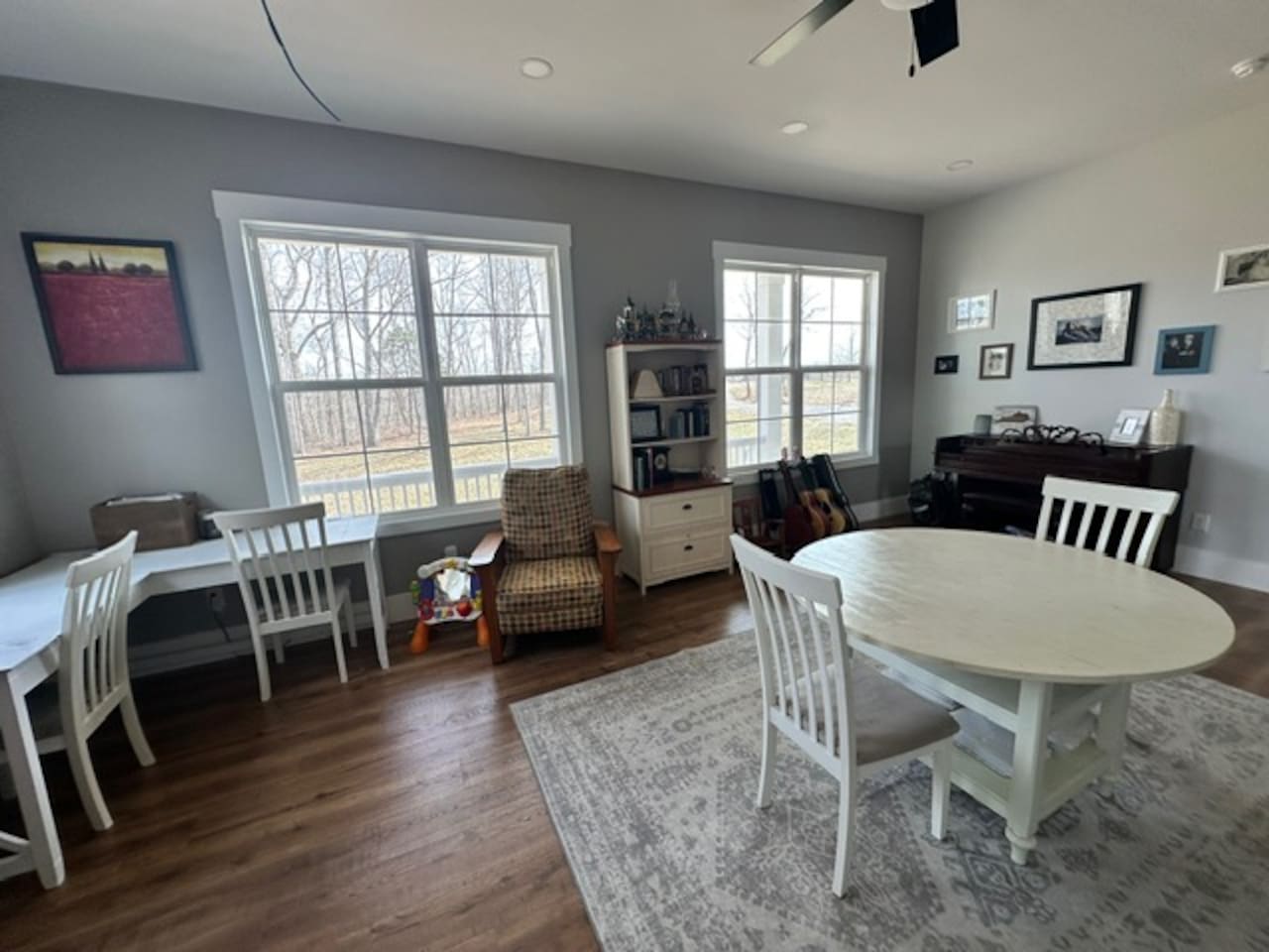 Our library features three work spaces, two comfy chairs for reading, PLENTY of books (we love the classics!), children's art supplies & crafts, as well as a piano and a few guitars. Beautiful views from these windows too. Open to living room/foyer.