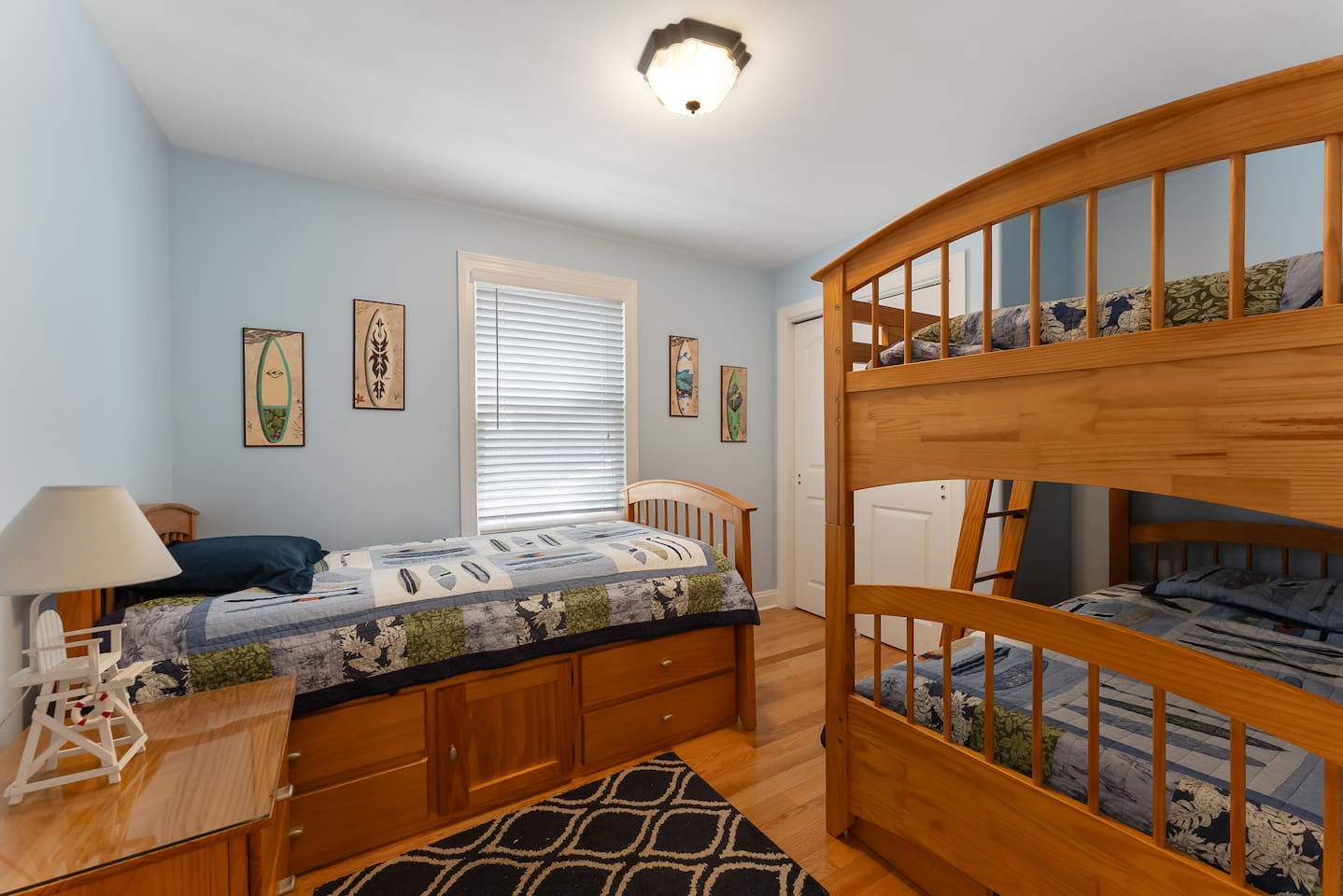 Bedroom features bunk beds and a single bed with a large closet for storage. 