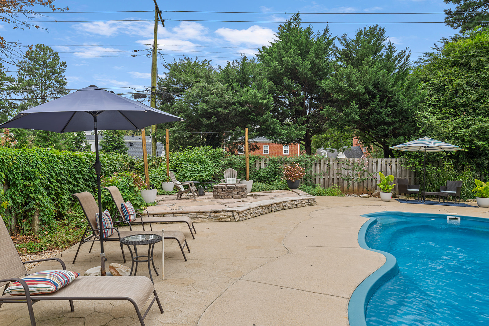 Outdoor Oasis: Relax by the sparkling pool, surrounded by lush greenery and charming seating!