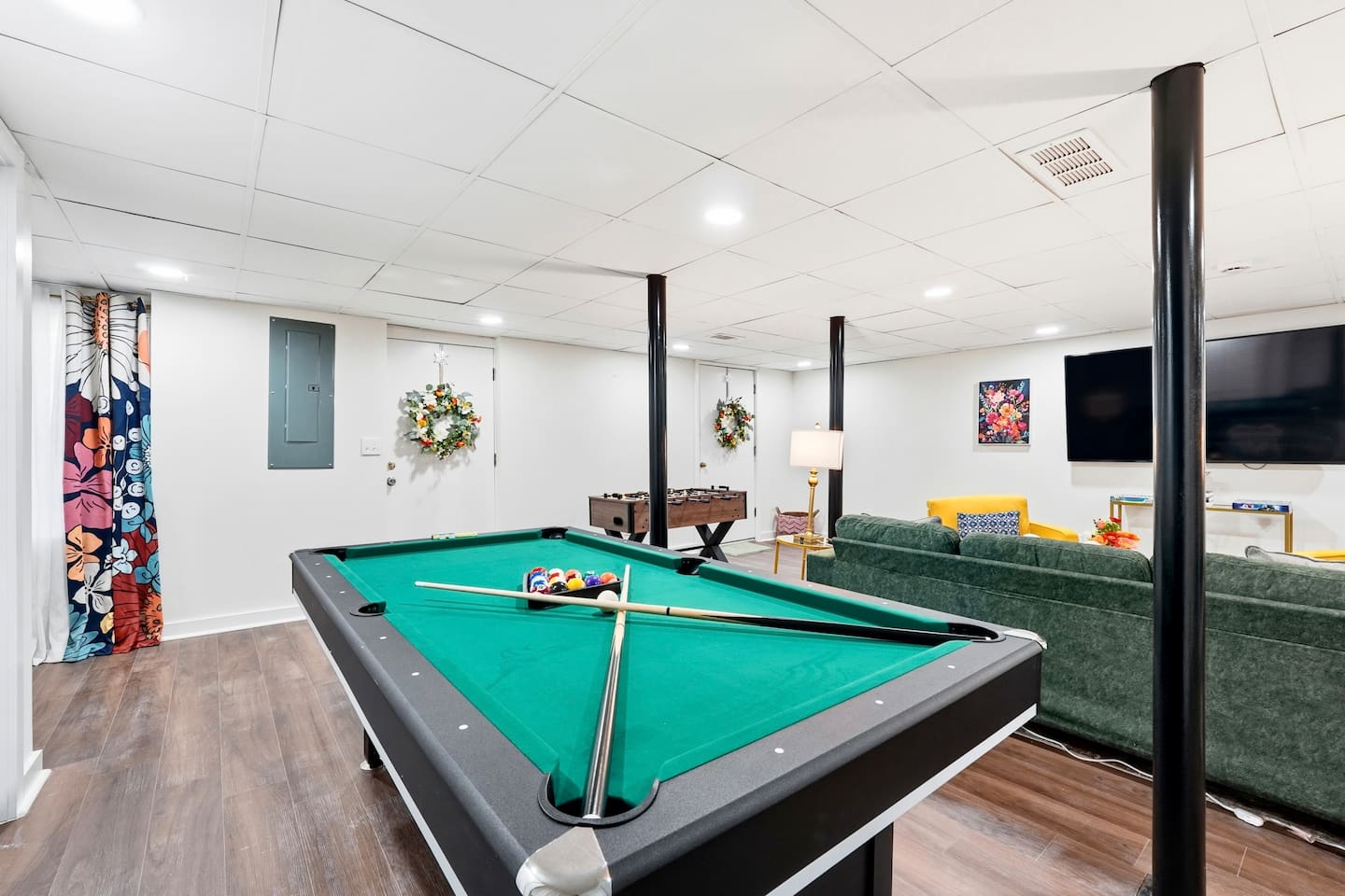 Amazing game room located in the basement, featuring a pool table, foosball table, and a stylish bar perfect for entertaining and relaxing with friends and family.